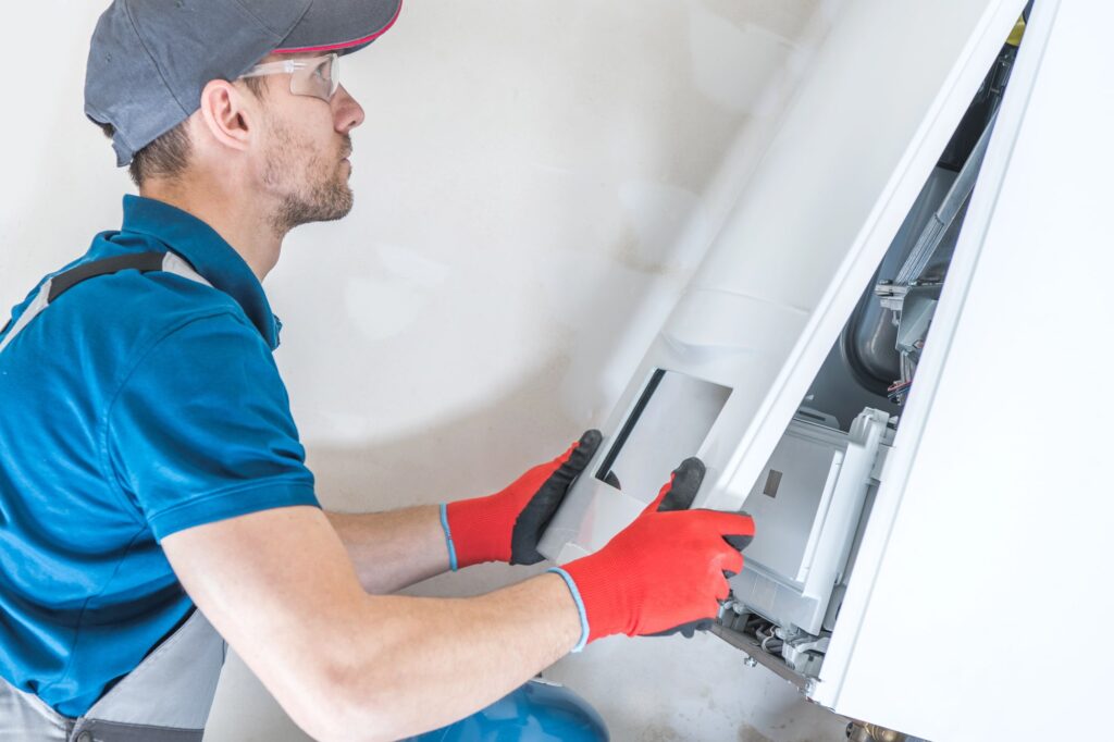 man resetting a furnace to DFW home | how to reset furnace